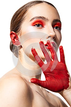 Woman with red makeup and painted hand