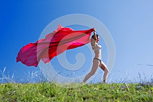 Woman with red material and nature photo