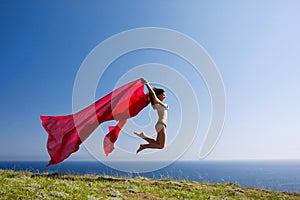 Woman with red material and nature photo