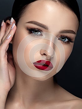 Woman with red matte finish lips closeup portrait