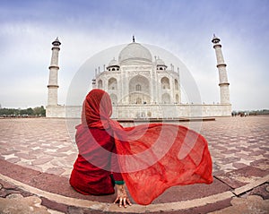 Woman in red near Taj Mahal