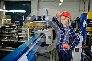 Woman in red safety helmet at metal tile roof manufacturing fact