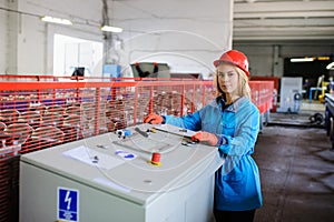 Woman in red safety helmet work as industrial worker