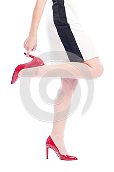 Woman with red shoes grabbing one leg heel