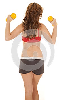 Woman red sports bra yellow weights back view