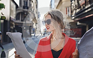 Woman in red suit looking skeptically at the documents