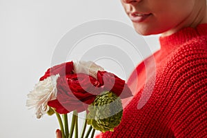 Woman in a red sweatshirt with flowers Buttercup on a white background.