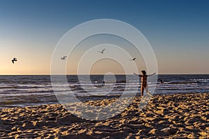 A woman in the red swimsuit on the beach