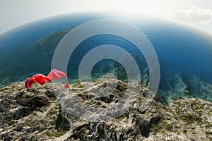 Woman with a red tissue on the beach