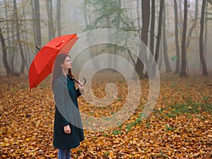 woman with red umbrella autumn forest nature fresh air