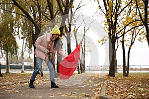 Woman with red umbrella caught in gust of wind outdoors