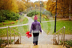 Woman with red umbrella comes down stair to wet photo