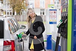 Woman refilling car with fuel