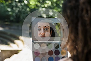 Woman is reflected in the make-up set