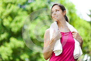 Woman refreshing after running at the city park