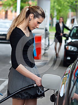 Woman refuel her car photo