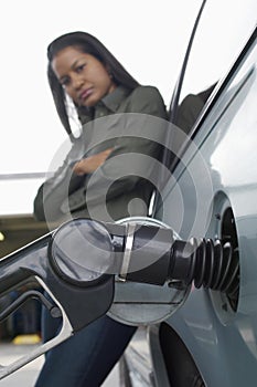 Woman Refueling Car At Gas Station