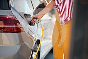 Woman refueling petrol in car-concept