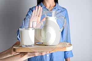 Woman refusing to drink milk. Food allergy concept