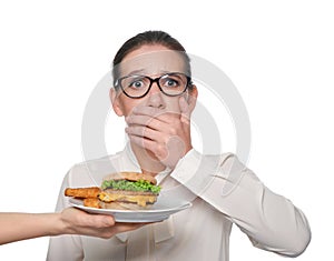 Woman refusing to eat unhealthy food on white background. Diet concept