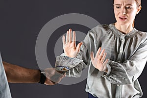 Woman refusing to take bribe on black background