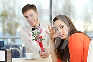 Woman rejecting a geek boy in a blind date photo