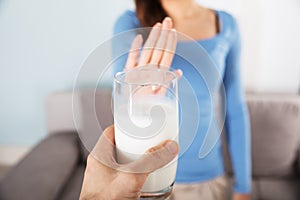 Woman Rejecting Glass Of Milk