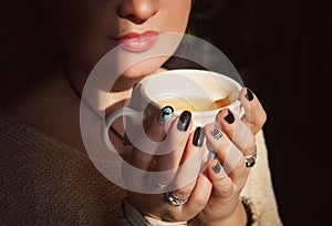 Woman relax with cup of tea in sunlight