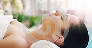 Woman, relax and face sleeping at spa for zen, physical therapy or healthy massage on bed at resort. Calm female person