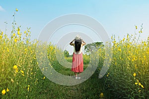 Woman relax in flowers field.