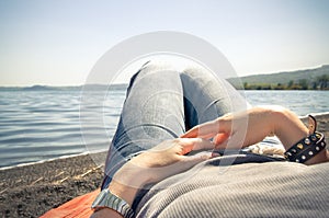 Woman relax lying by the lake