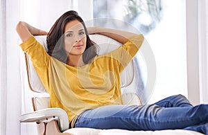 Woman, relax and portrait on work break in a chair in a home with smile and calm in a lounge with rest. Happy, chill and