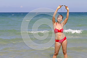 Woman relax with red bikini on beach at Ban Krut