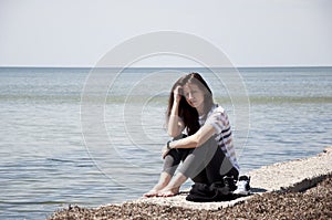 Woman relax on sea shore. summer holiday and vacation. sea travel of stylish girl. loneliness and thinking about future. waiting f
