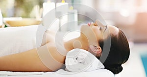 Woman, relax and sleeping on massage bed at spa for zen, physical therapy or healthy wellness at resort. Calm female