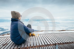 Woman relax in top view point with mountain city winter panorame