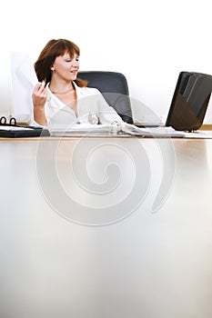 Woman relax using paper sheet as fan