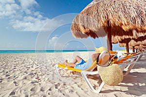 Woman at relaxation under parasol