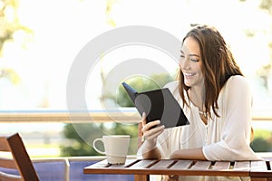 Woman relaxed reading a book in an ebook
