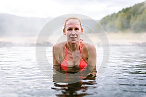 Woman relaxes and enjoys natural hot thermal water roman spa