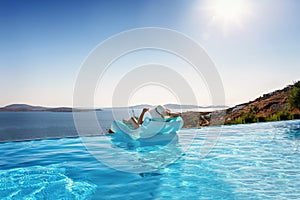 Woman relaxes on a float under the Mediterranean sun