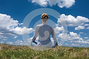 Woman relaxes on the mountain at beautiful sunny day