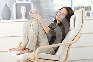 Woman relaxing in armchair