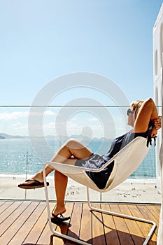 Woman relaxing on the balcony