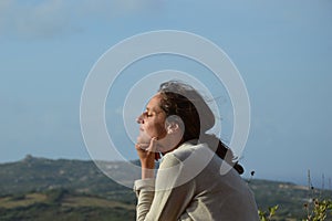 Woman relaxing on the balcony in Santa Teresa di Gallura... view from Ruoni