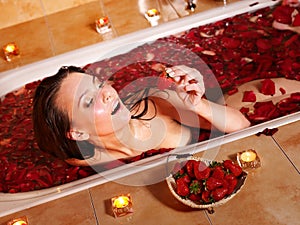 Woman relaxing in bath.