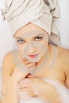 Woman relaxing in bathtub.