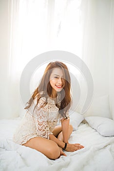 Woman Relaxing in bed and relaxing in her living room