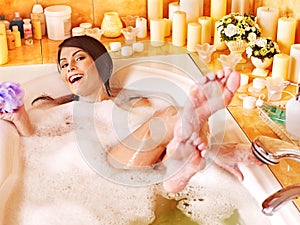 Woman relaxing at bubble bath.