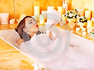 Woman relaxing at bubble bath.